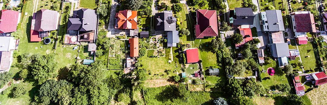 An aerial photo of 9 houses on 9 plots of land to indicate that a foreigner can build and own a house in the Philippines but not the land it is built on. Inheritance Rights of a surviving spouse Philippines, Can a foreigner inherit Philippine land