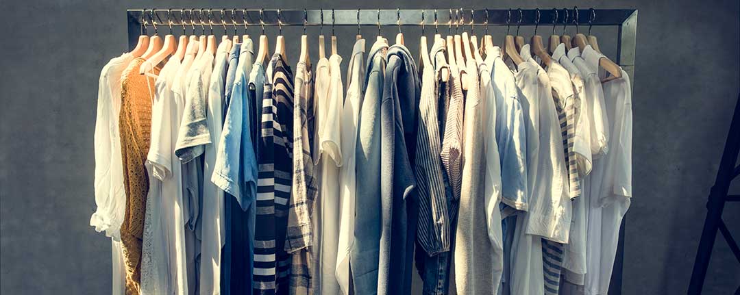 A row of mens shirts and T-shirts hanging from a metal clothes rail symbolizing that clothes are not considered part of the Conjugal Property when a marriage dissolves.
