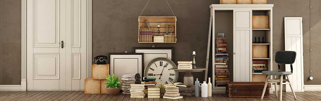 A large room with brown walls and a pile of furniture, books, plants and boxes ahead of moving out of a house. Article: A simpler way to divide Conjugal Property by Lawyers in the Philippines