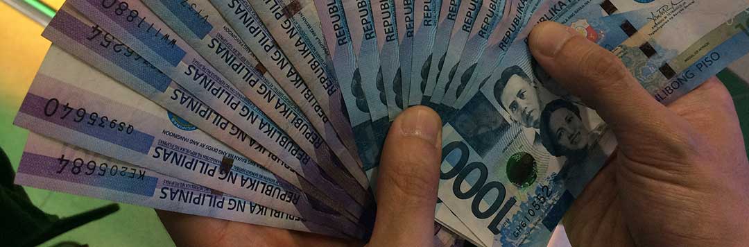 A photo of two hands fanning out a lot of One Thousand Pesos bills symbolizing that after court proceedings, each Spouse will then control his own Estate.