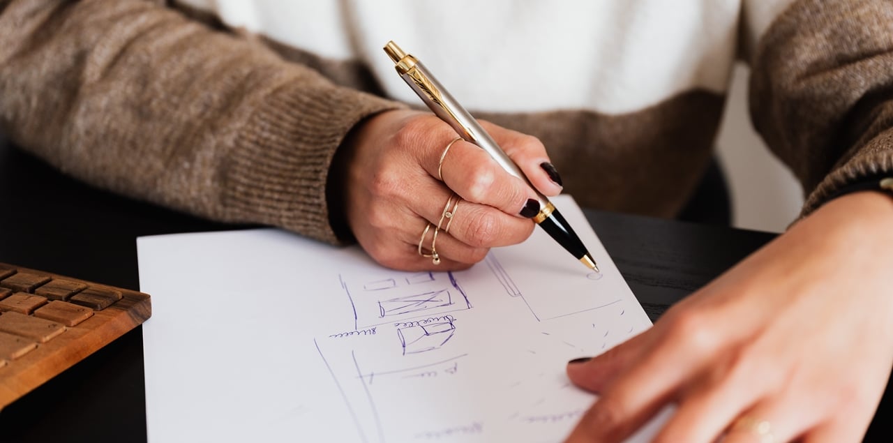 A photo of a man sketching the location of his house on a piece of paper as part of his Sworn Certificate of Residency. This may be needed for an Annulment case in the Philippines