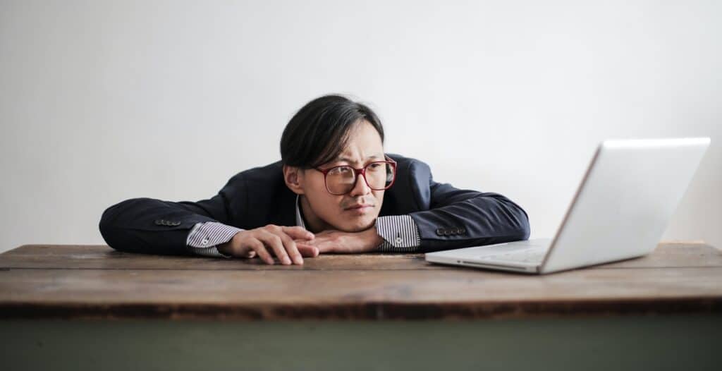 A man waiting in front of his computer