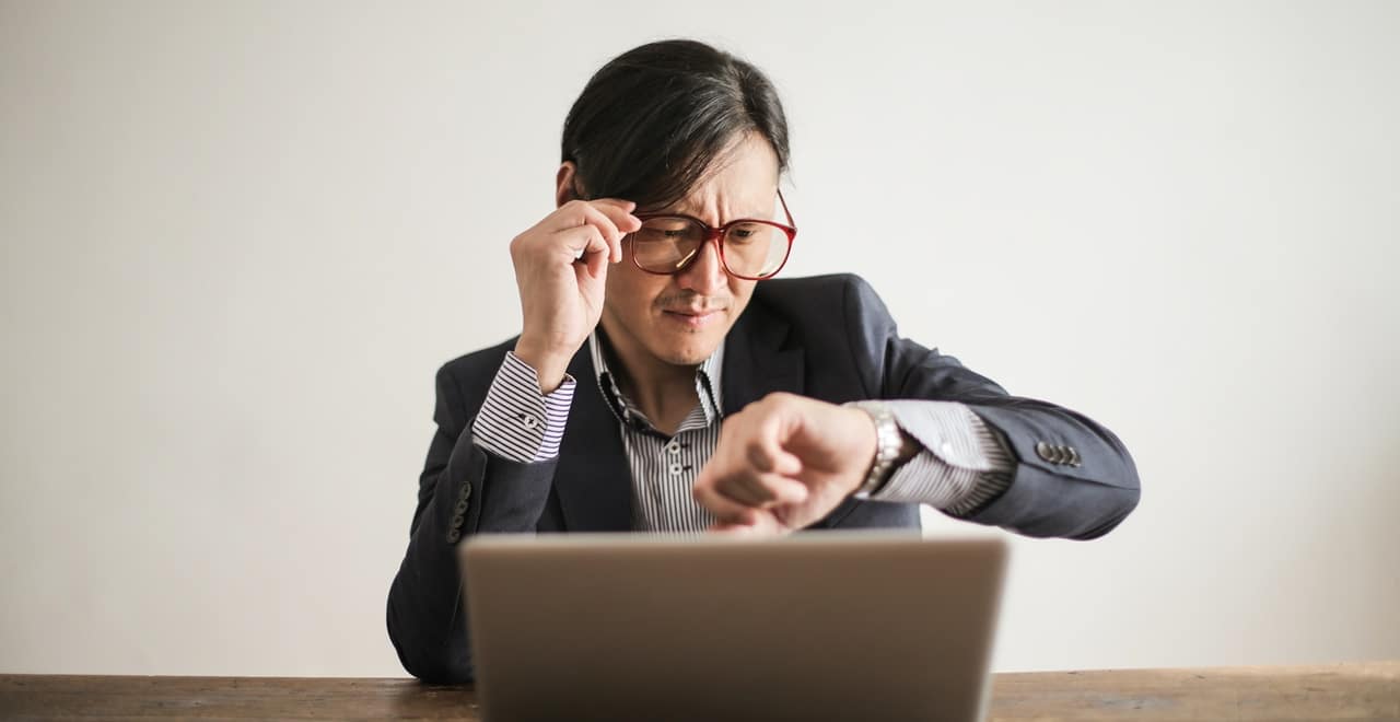 A secretary checking his wrist watch