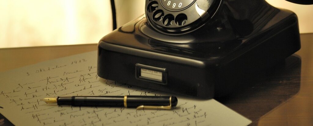 A photo of a fountain pen on top of a handwritten Holographic Will and an old telephone on the table. A Will must comply with Philippine law whether it is a Notarial Will or Holographic Will to be valid.