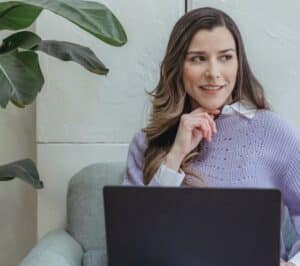 A thinking lady in front of her computer
