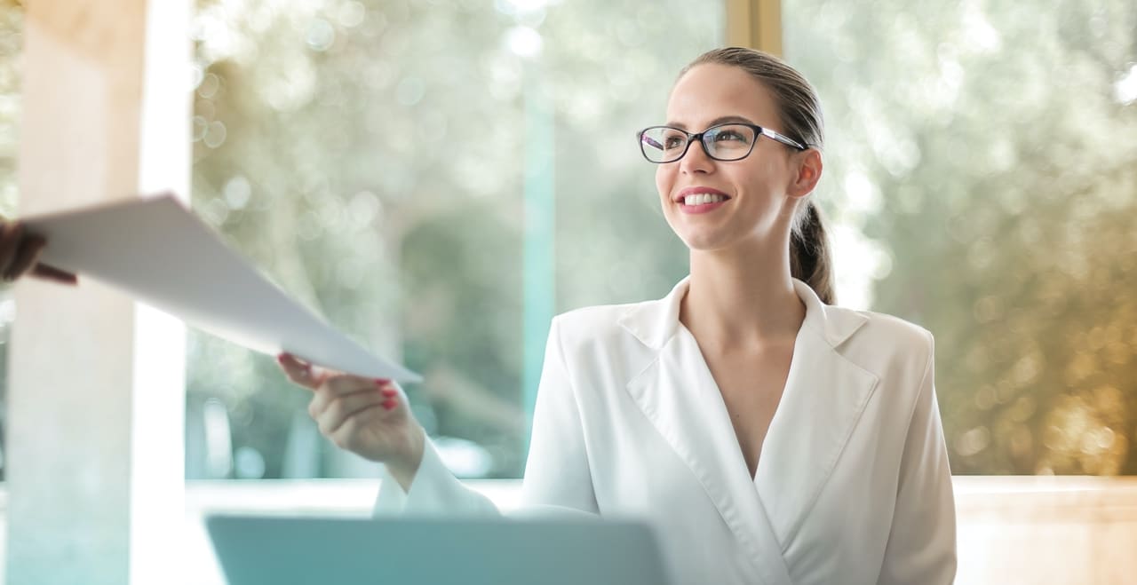A lady passing a document