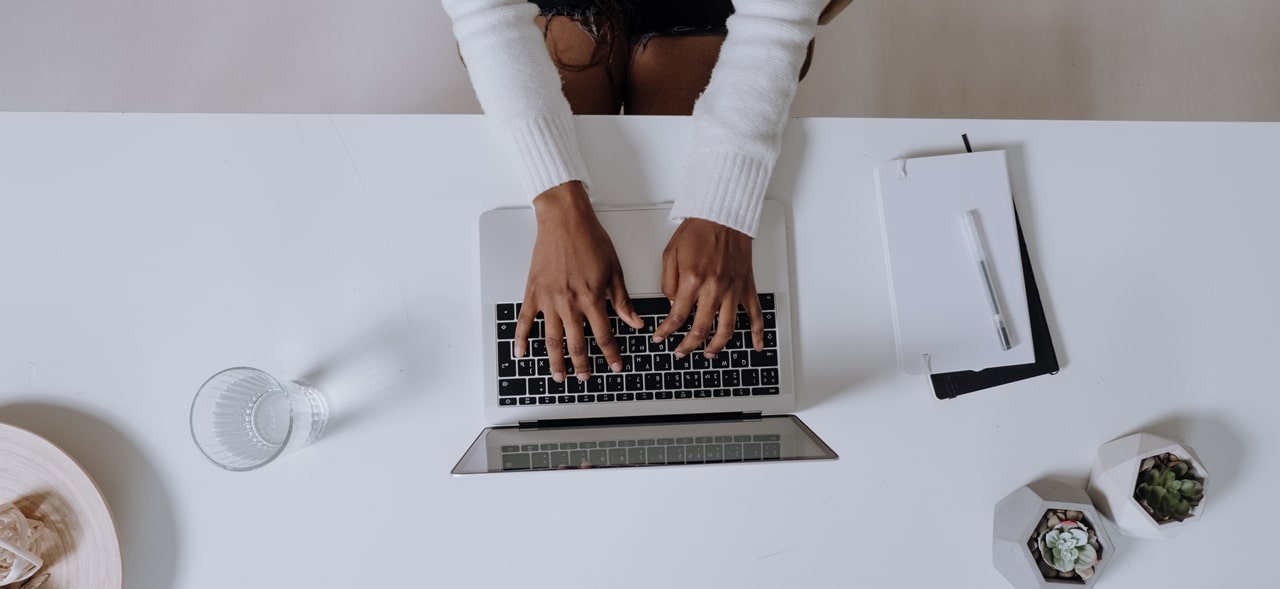 A person typing on her computer