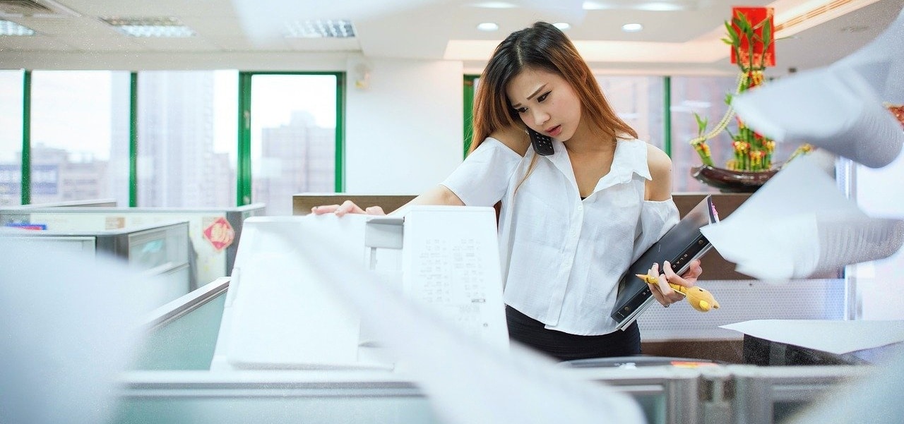 A lady photocopying papers