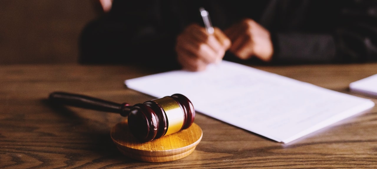 A judge signing a document in court