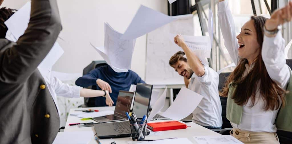Joyful board members tossing papers symbolizing Tax Free Exchange in the Philippines
