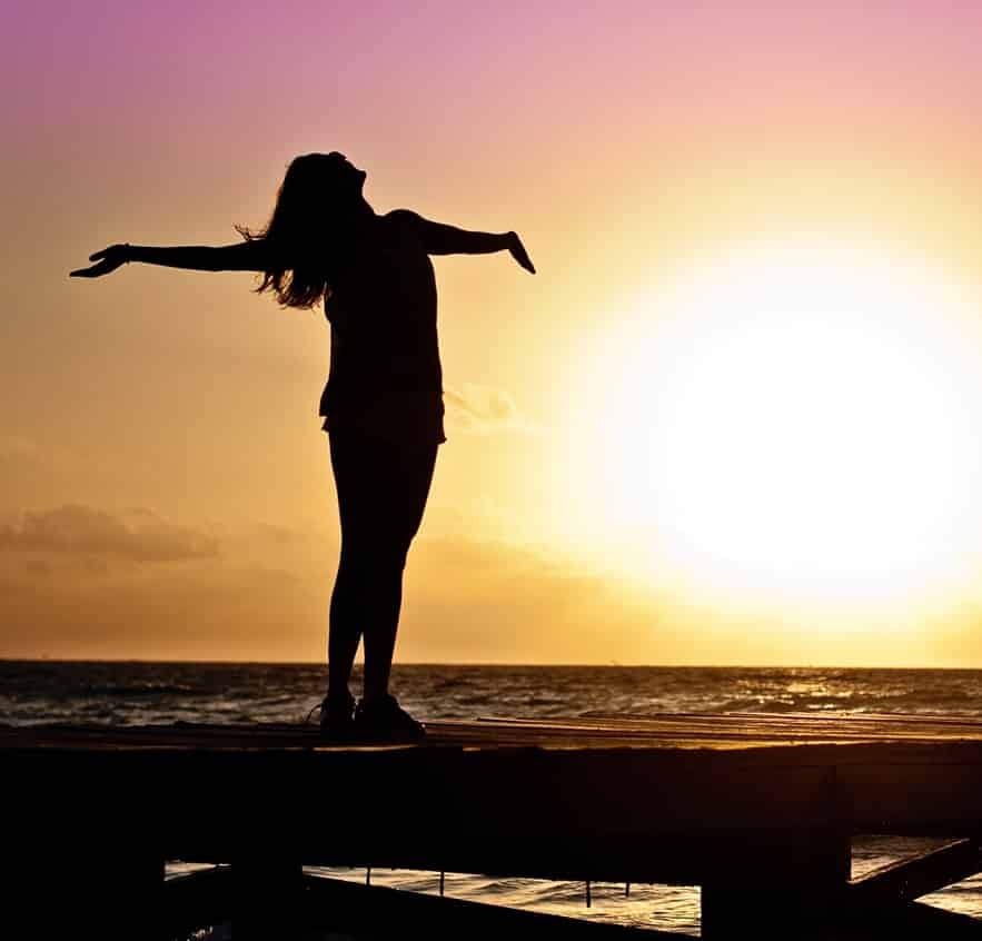 A woman with her arms open wide symbolizing Tax Free Exchange in the Philippines