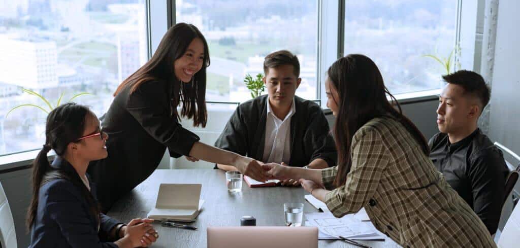 Board members shaking hands symbolizing a Tax Free Exchange of property in the Philippines.