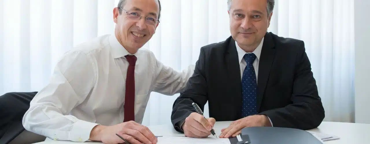 Picture of a Philippine tax lawyer with his satisifed client preparing BIR documents for audit purposes.