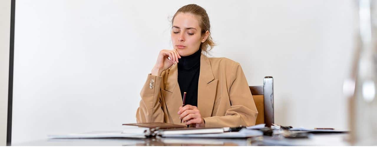 A woman preparing documents to open Treasurer in Trust Account or TITF.