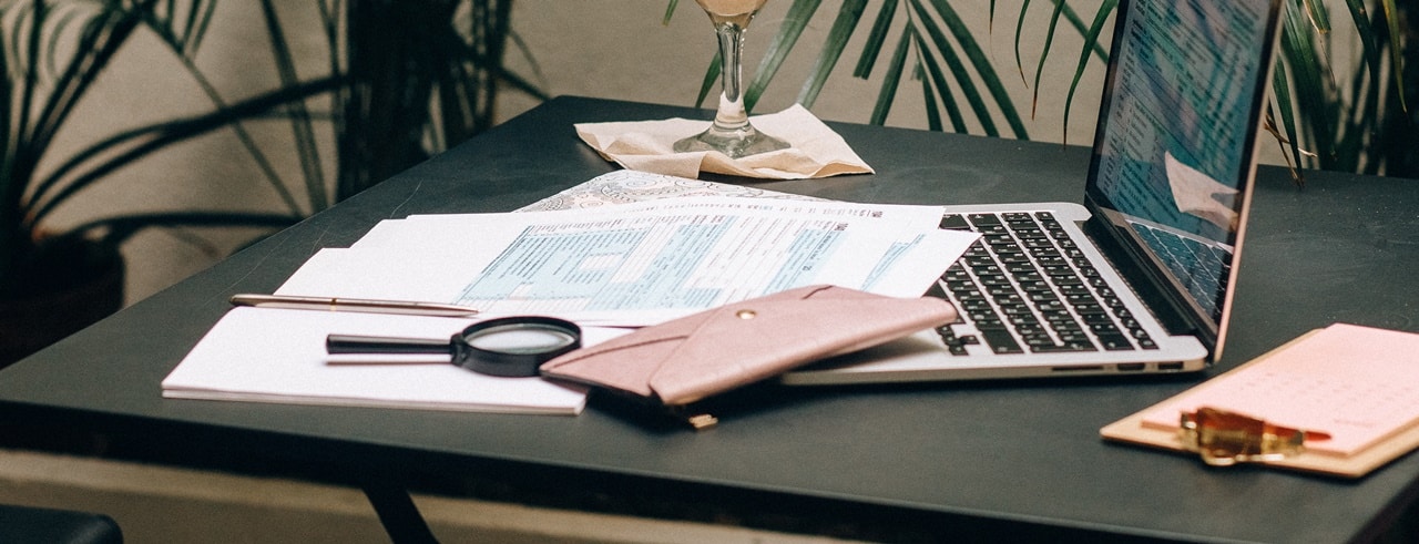 TITF corporate bank account requirements Philippines on the table alongside a laptop.
