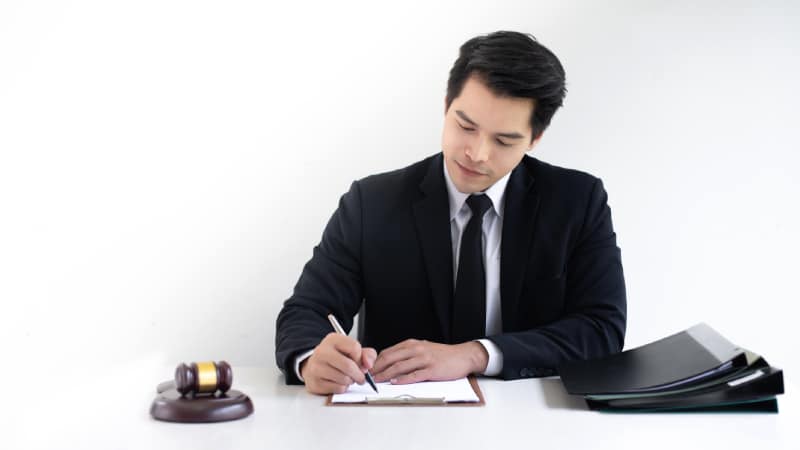 Asian man lawyer working at his desk in an office.