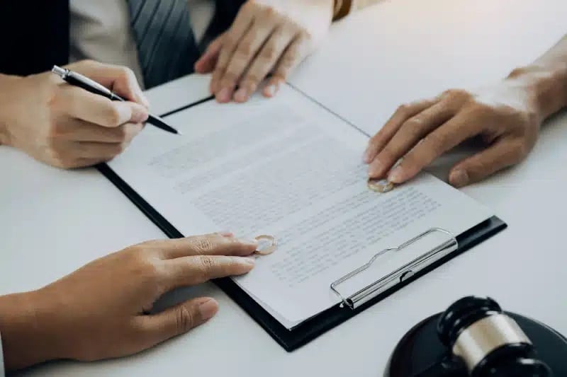 Couple is divorced who handed their engagement ring to the divorce documents that the lawyer was clarifying.