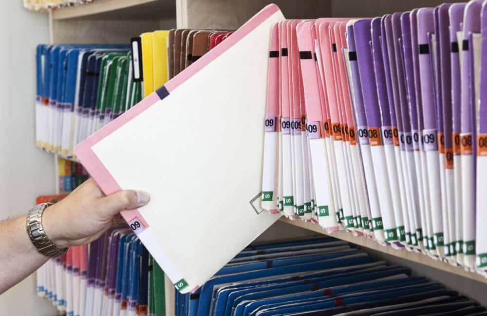 A open bookshelf of property documents. As an Extrajudicial Settlement of Estate Law Firm, we will go through your documents such as Land Titles, Tax Declarations and other supporting documents to assess the situation.