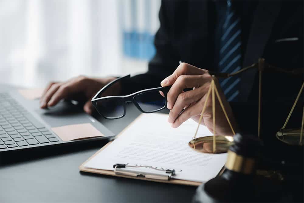 A Will must be signed by the testator, such as in this picture of a man in a black suit signing his will.