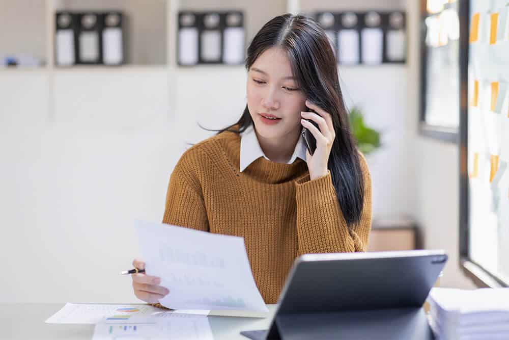 A PH lawyer discussing a Notarial Will & family details with her client as frequent coordination is needed.