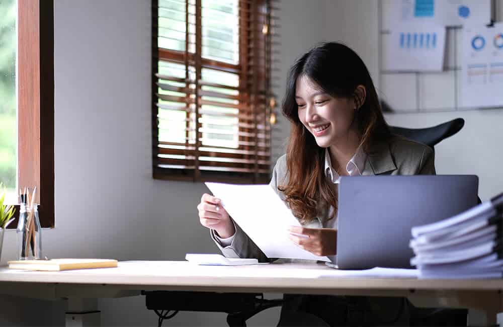 As Property Law Firm, we have the experience to guide you in gathering documents such as proof of ownership for a successful Reissuance or Reconstitution case as symbolized by a photo of a lady examing property documents.