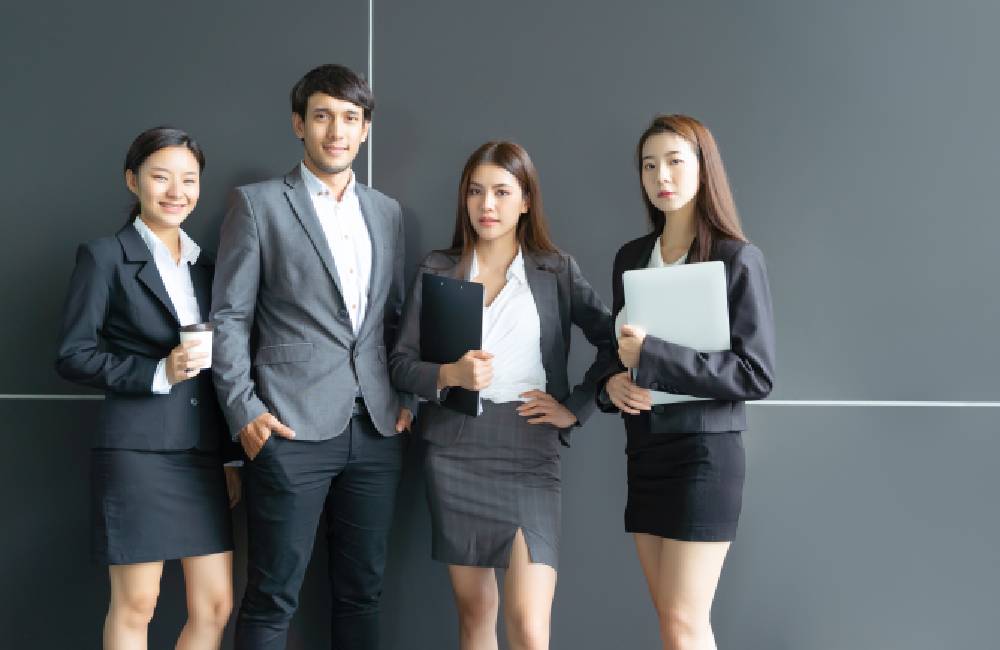 A photo of business people with document as a Branch Office will need complete foreign company registraion documents as well as other information as part of the submission.