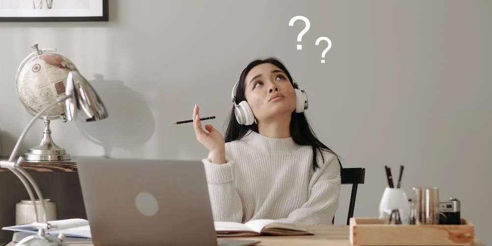 A woman in front of her computer thinking deeply with two floating question marks thinking about whether her marriage which was done even if there was a lack of parental consent is still valid