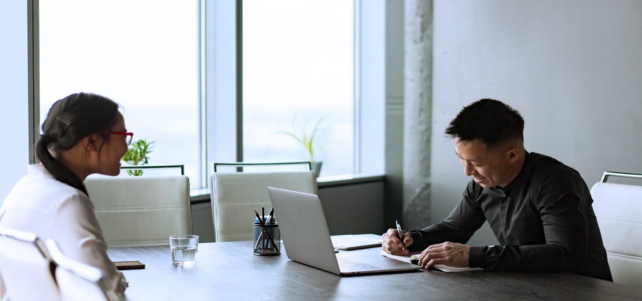 A man and a woman in a table having a discussion