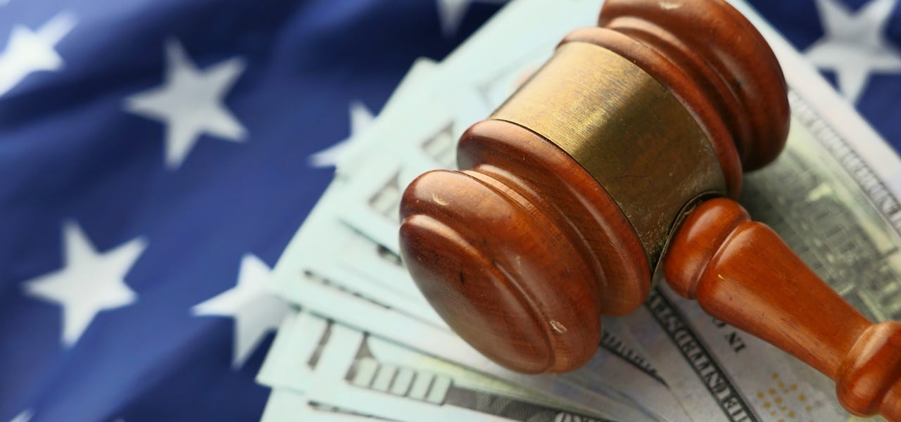 A gavel over dollar bills