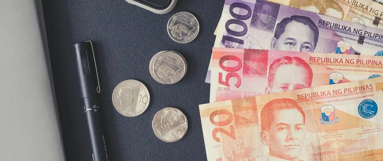 Philippine peso coins and bills on a table
