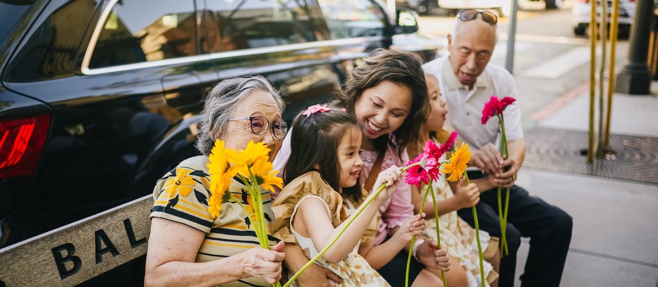 A happy family sitting on a park bench