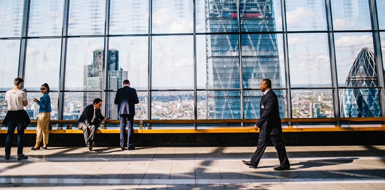 Busy people in a building with glass wall