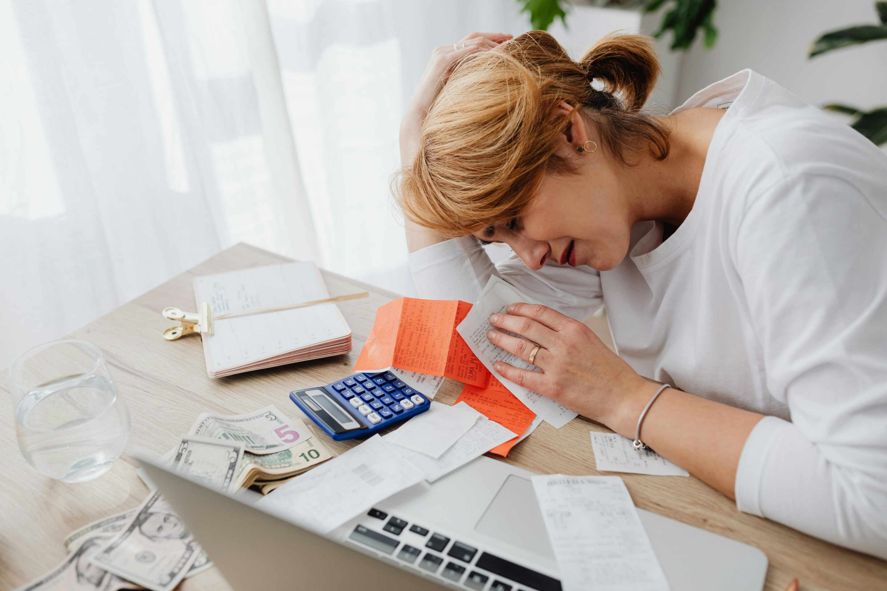 A woman reviews documents and uses a calculator to estimate the timeline and costs of filing a Declaration of Nullity case in the Philippines, focusing on legal fees and procedures.