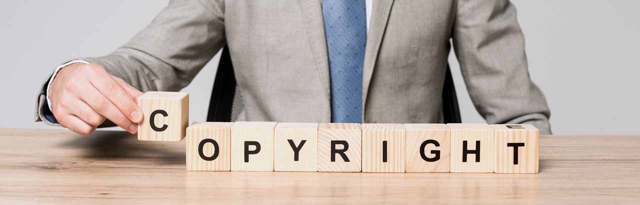 A man in formal attire forming the word