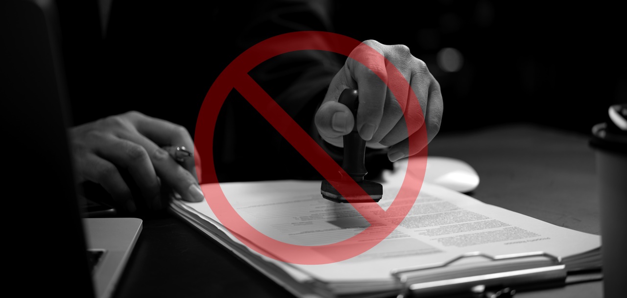 A person stamping a document with a