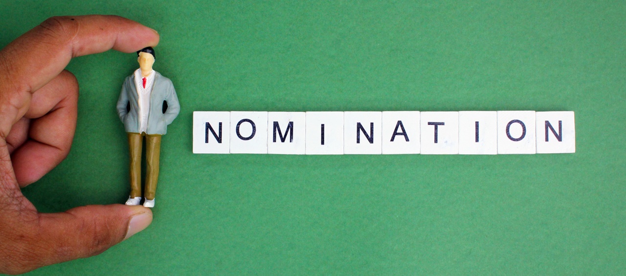 A person holding a human figure beside the word