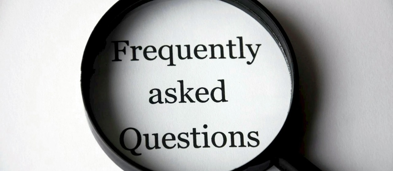 Words “Frequently Asked Questions” on a magnifying glass symbolizing the FAQs about 13a Visa in the Philippines.