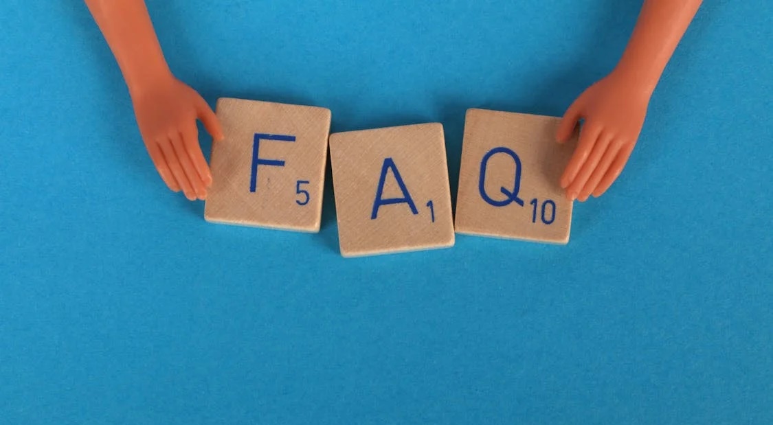 Scrabble tiles forming the word FAQ